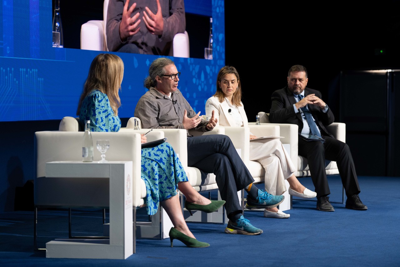 James and panel on stage in Marrakech