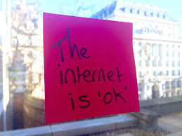 Post-it note on a window saying 'the internet is ok'