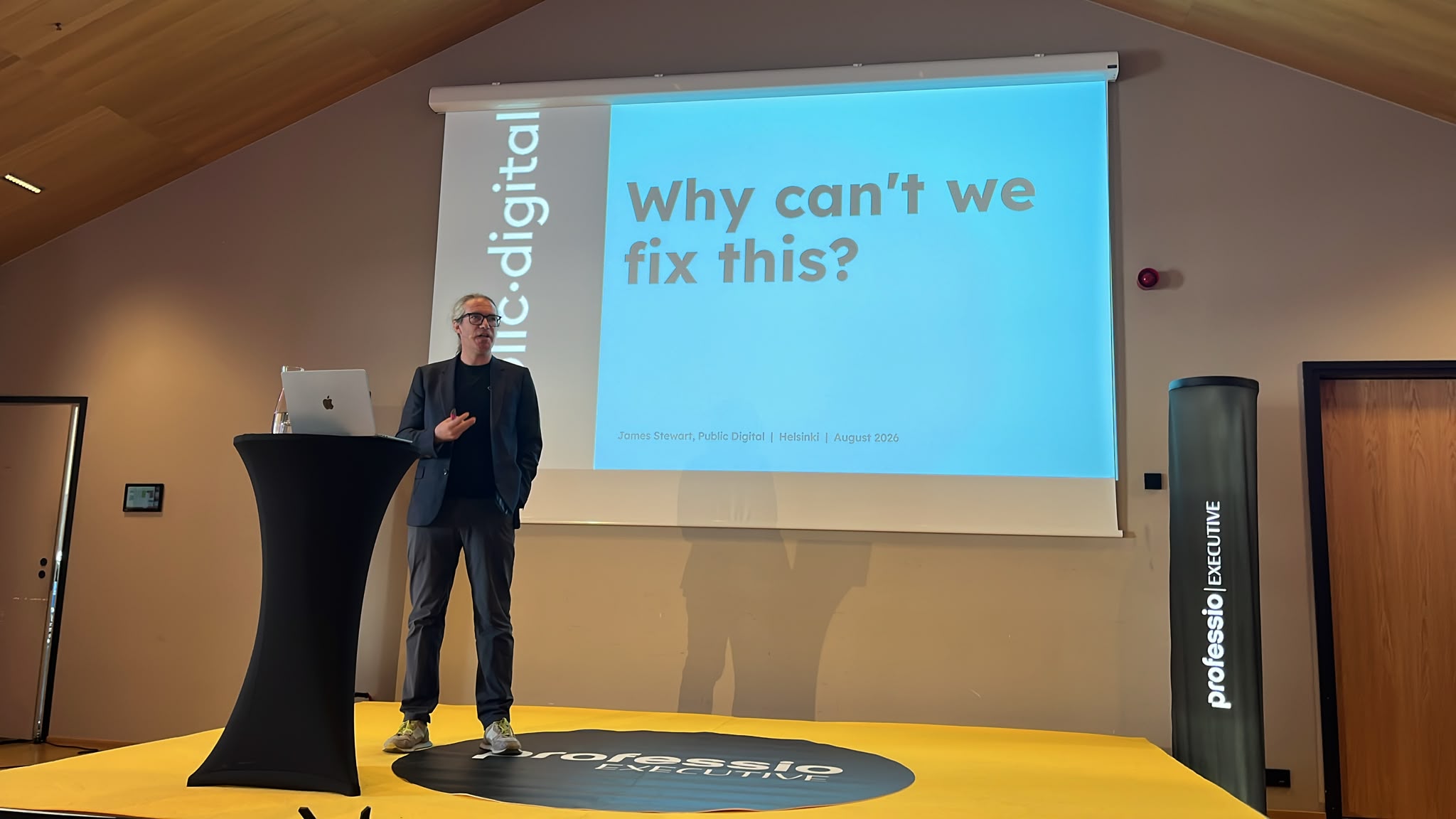 James in front of a slide asking 'Why can't we fix this?'
